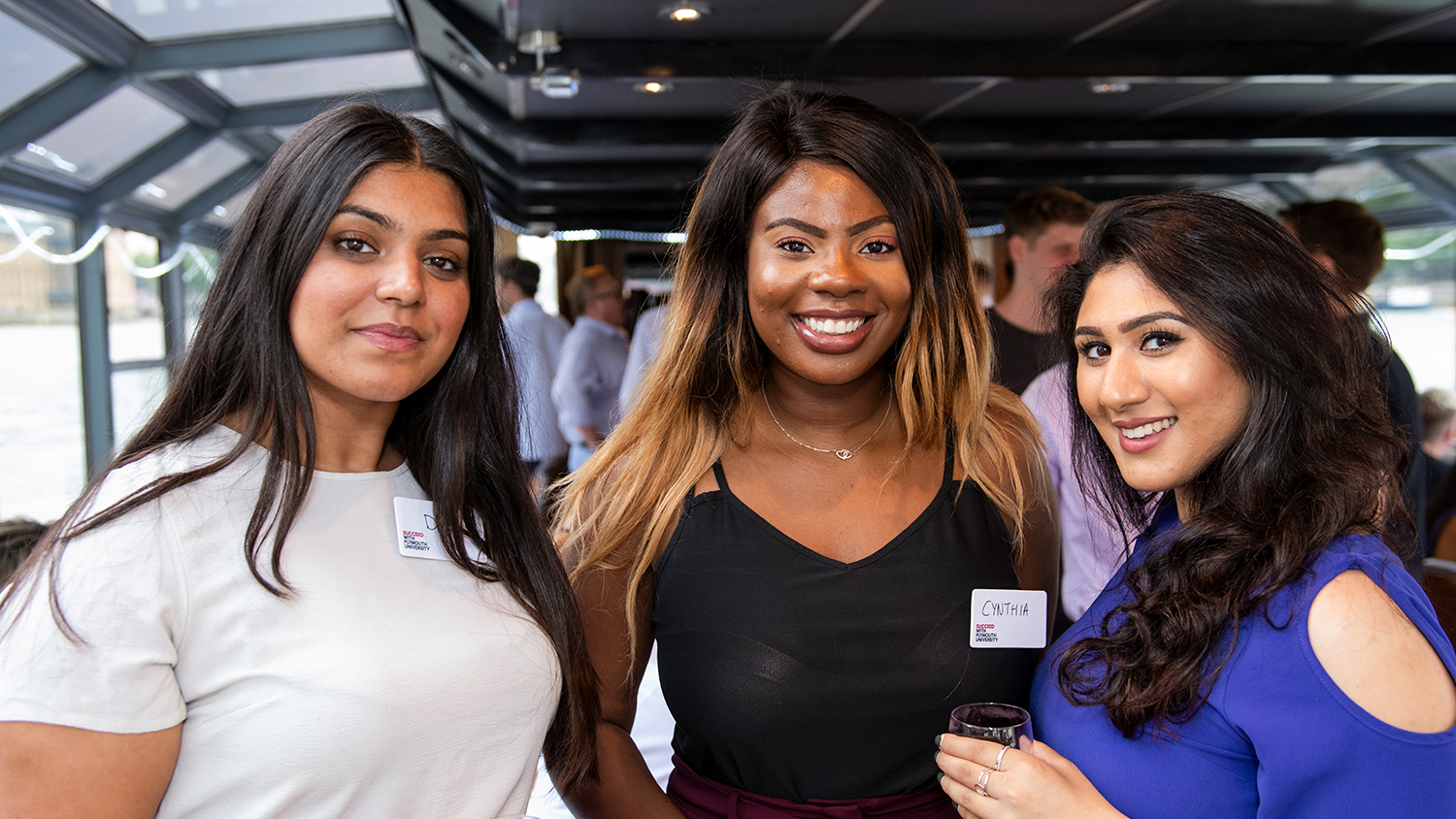 Three alumni holding drinks during the London alumni network
Summer Social, July 2018