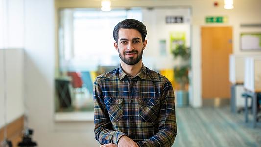Student in library looking to camera