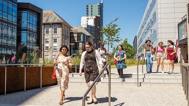 Open day visitors walking through the centre of campus