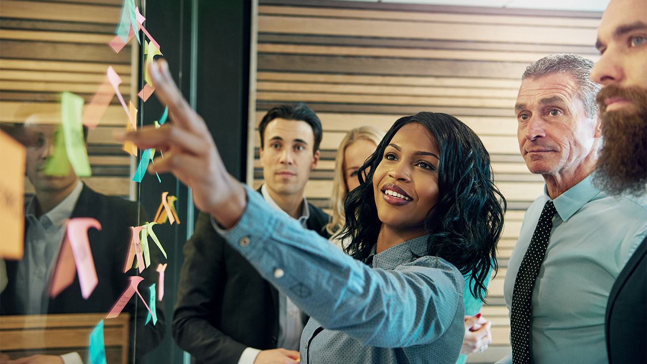 Woman explaining the plan to office team