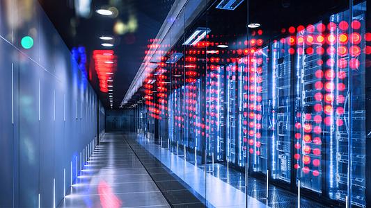 High-Tech Modern Data Center with Illuminated Server Racks and Digital Displays. Getty 2206650227