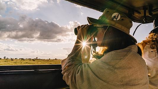 Zoology student on safari during a Kenya fieldtrip (full-bleed)