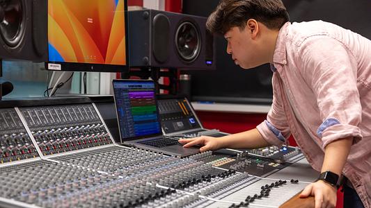 International Music Production student, Pongsatorn (Porsche) using music and sound production equipment 