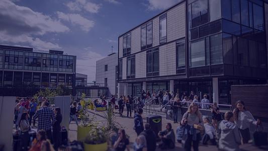 University of Plymouth students relaxing on the Students' Union roof outside the library
