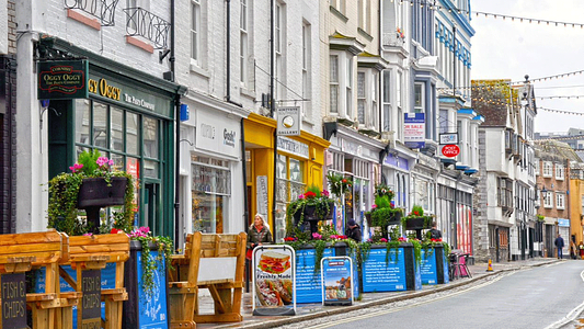 Multi coloured shops line the cobbled streets of Plymouth's historic Barbican